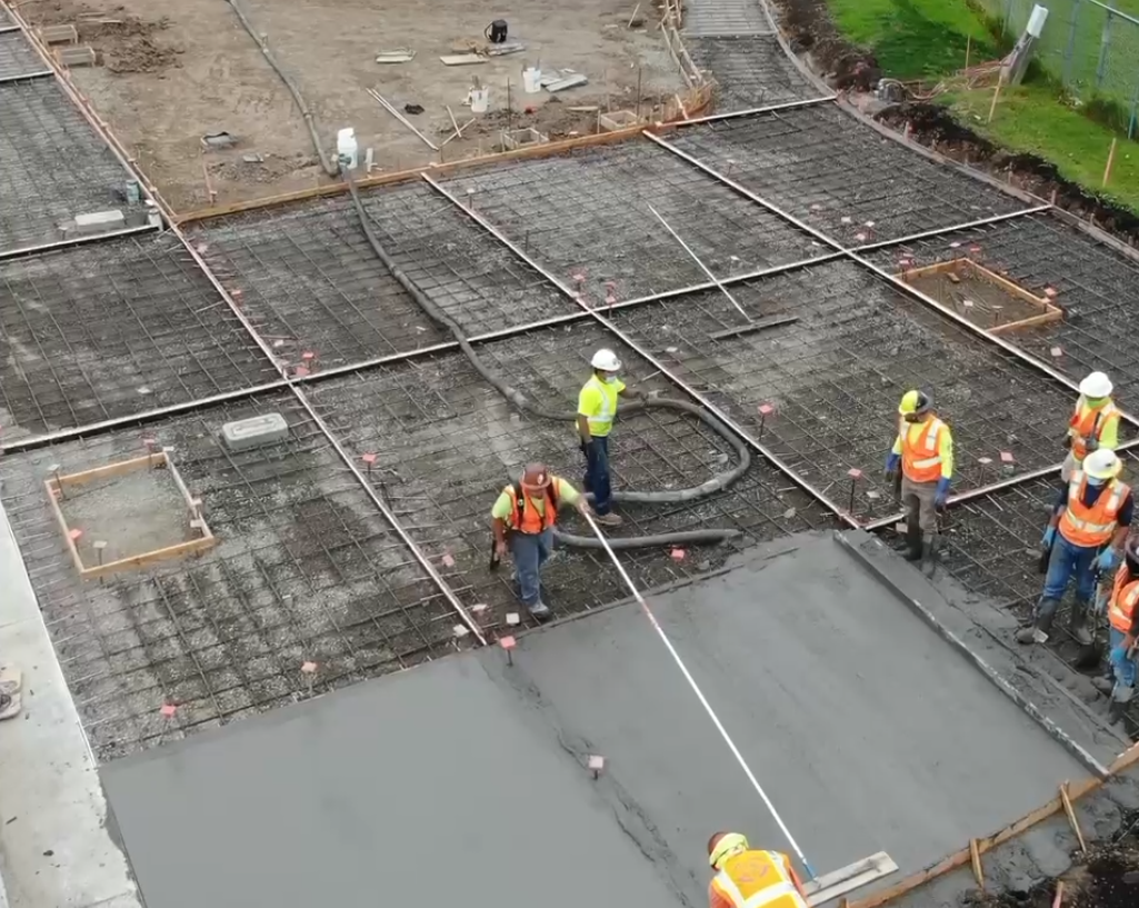 Exterior flatwork and site concrete being finished